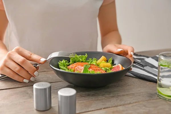 Woman Eating Fresh Salad Fish Wooden Table — Stock Photo, Image