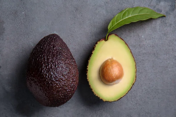 Aguacates Maduros Sobre Fondo Texturizado Gris —  Fotos de Stock