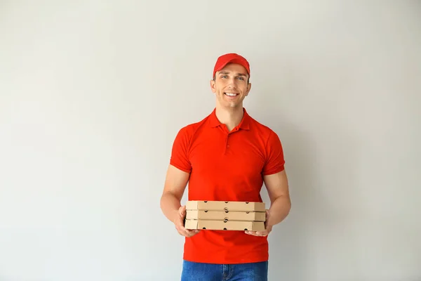 Young Man Pizza Boxes Light Background Food Delivery Service — Stock Photo, Image