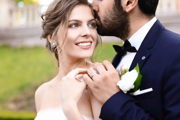 Knappe Jonge Bruidegom Kussen Zijn Gelukkige Bruid Buitenshuis — Stockfoto