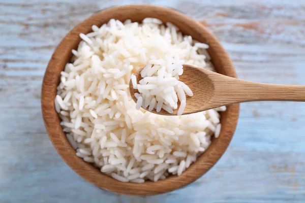 Eating of tasty boiled rice with spoon, closeup