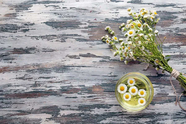 Bowl Chamomile Essential Oil Fresh Flowers Wooden Table — Stock Photo, Image