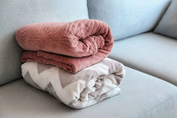 Folded warm plaids on sofa