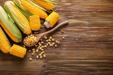Ahşap masa üzerinde taze corncobs ile kompozisyon