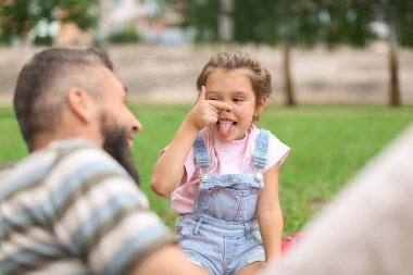 Küçük kız ve babası açık havada komik portresi