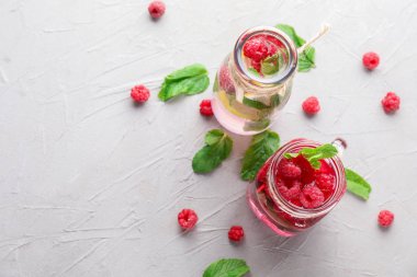 Işık tablosu üzerinde taze ahududu mojito şişe ve cam kavanoz