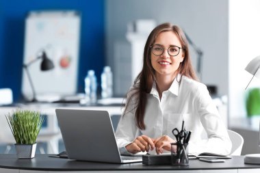 Young businesswoman working in office clipart