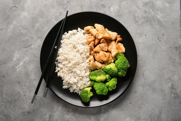 Delicious boiled rice with meat and broccoli on plate