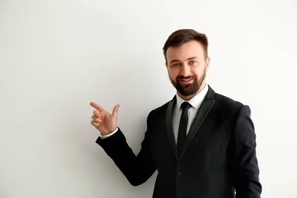 Handsome Businessman Pointing Something Light Background — Stock Photo, Image