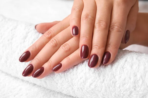 Young woman after getting professional manicure in beauty salon, closeup