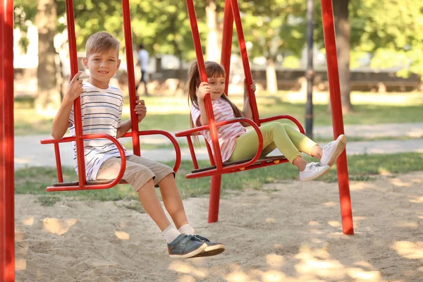 Cute Little Children Swinging Outdoors — Stock Photo, Image