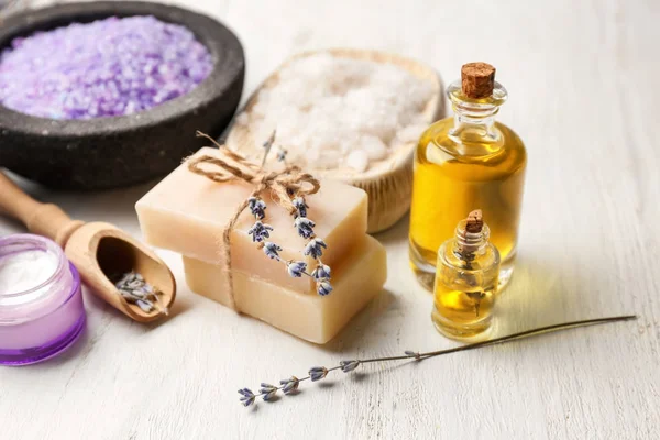Spa composition with cosmetic products and lavender on table