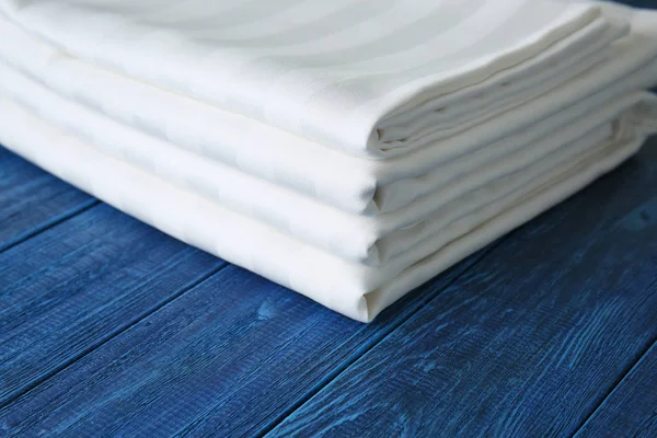 Stack Clean Bed Sheets Color Wooden Background Closeup — Stock Photo, Image