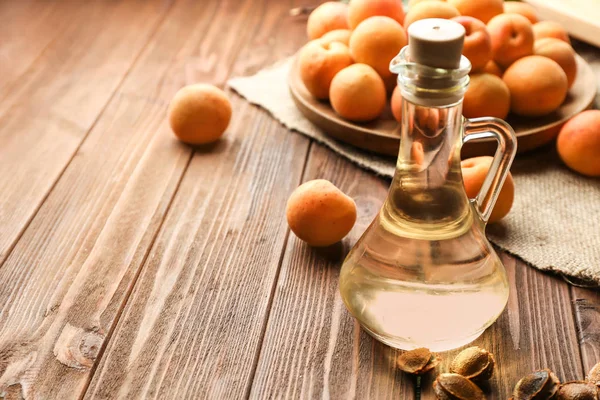 Glass Jug Apricot Essential Oil Wooden Table — Stock Photo, Image