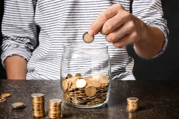 Man Putting Coins Glass Jar Table Savings Concept — Stock Photo, Image