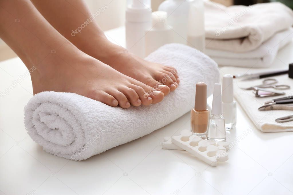 Young woman after getting professional pedicure in beauty salon, closeup