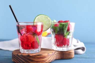 Ahşap masa üzerinde taze ahududu mojito bardak