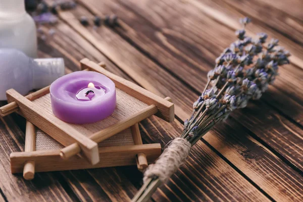 Burning candle for spa and lavender on wooden table