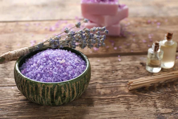 Bowl with sea salt for spa and lavender on wooden table