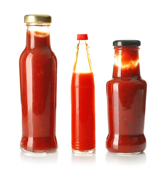 Bottles with tasty sauces on white background