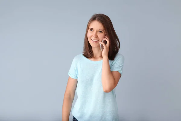 Beautiful Young Woman Talking Phone Light Background — Stock Photo, Image