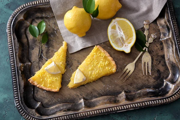 Pieces of tasty lemon pie on metal tray