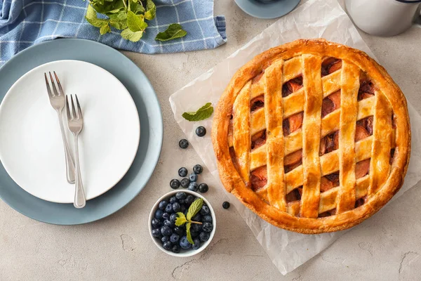Delicious peach pie and blueberry on light table