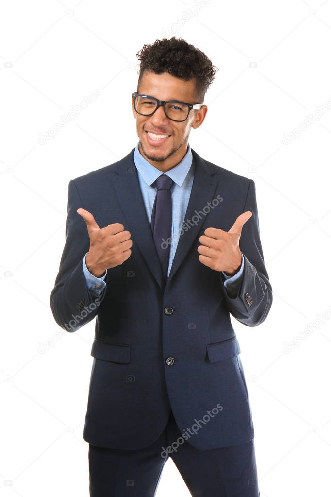 Handsome African-American businessman showing thumb-up on white background