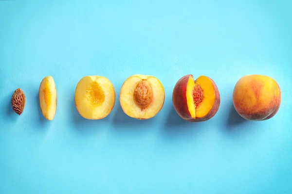 Composition with sliced peaches on color background