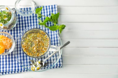 Ahşap masa üzerinde lezzetli papatya çayı fincan