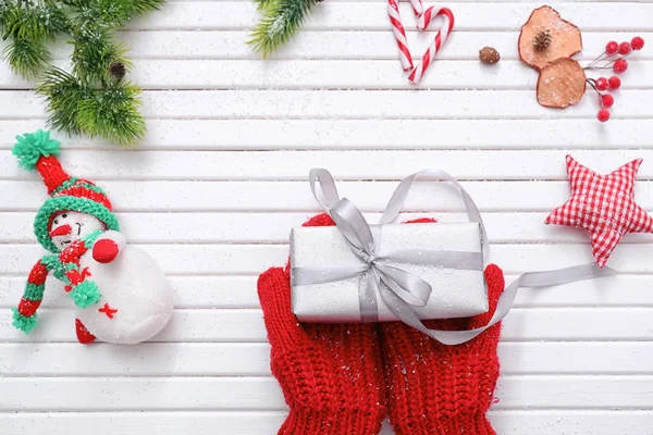 Hands Mittens Holding Christmas Gift Box White Wooden Background — Stock Photo, Image