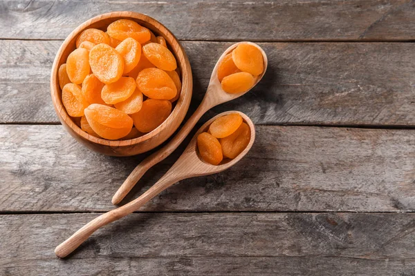 Bowl Spoons Dried Apricots Wooden Table — Stock Photo, Image