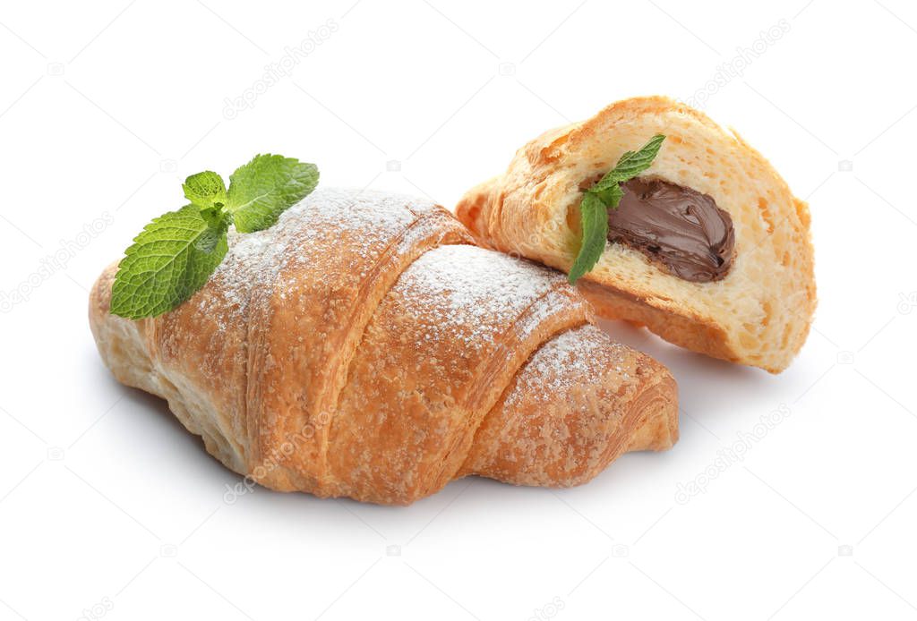 Tasty croissants with chocolate cream on white background