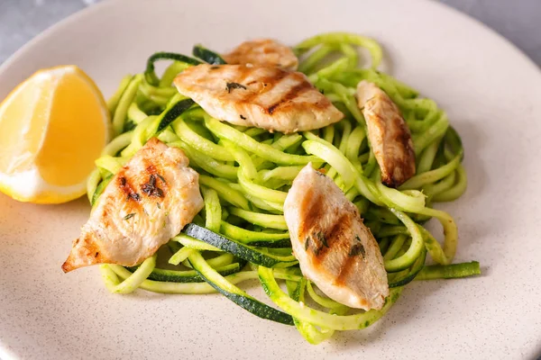 Zucchini spaghetti with meat on plate, closeup