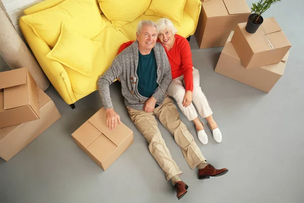 Mature Couple Sitting Floor Boxes Sofa Moving New House — Stock Photo, Image