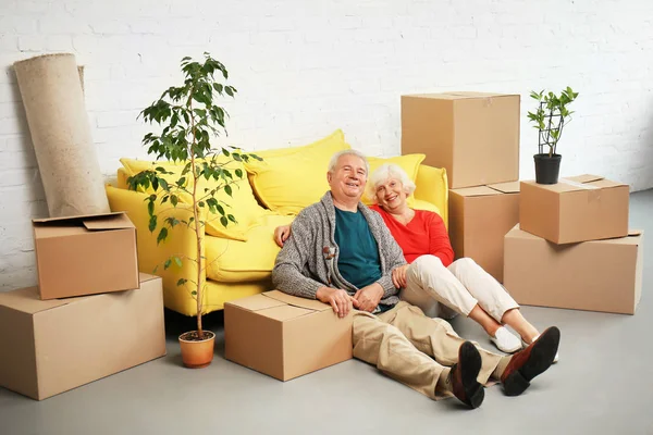 Mature Couple Sitting Floor Boxes Sofa Moving New House — Stock Photo, Image