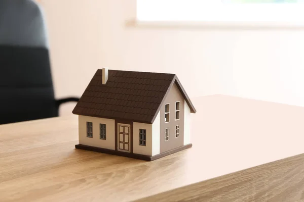 House model on wooden table. Mortgage concept