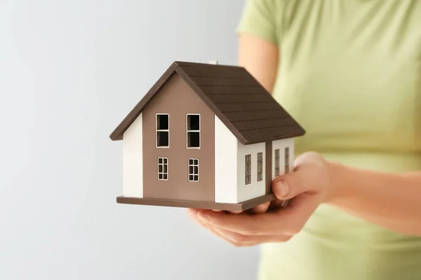Woman Holding House Model Grey Background Closeup Mortgage Concept — Stock Photo, Image