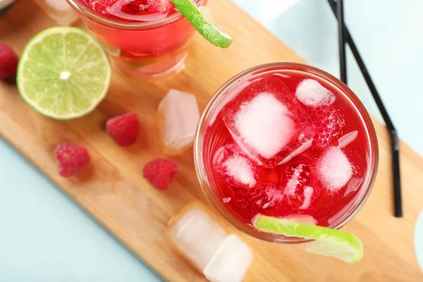 Glass of fresh raspberry cocktail on board