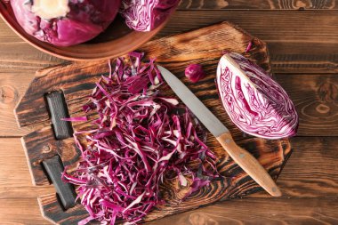 Cut red cabbage on wooden board clipart