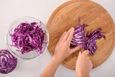 Kadın kesme Olgun kırmızı lahana beyaz masa