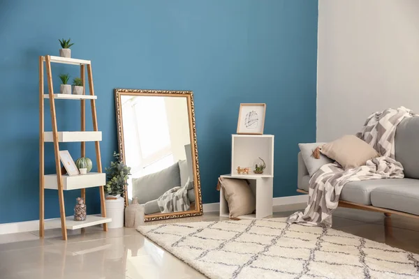 Living room interior with big mirror and stylish furniture