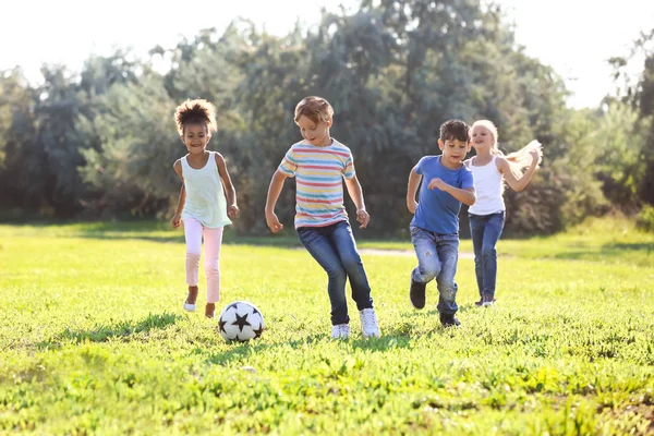 Cute Little Children Playing Football Outdoors Stock Photo