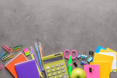 Set of school stationery with calculator on grey background clipart