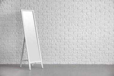 Beyaz tuğla duvar yakınındaki büyük ayna