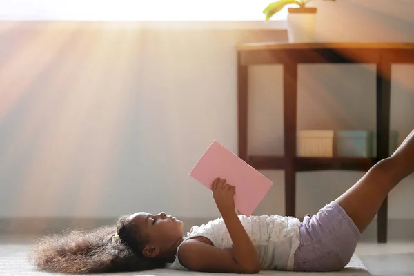 Little African American Girl Reading Book While Lying Floor Home — Stock Photo, Image