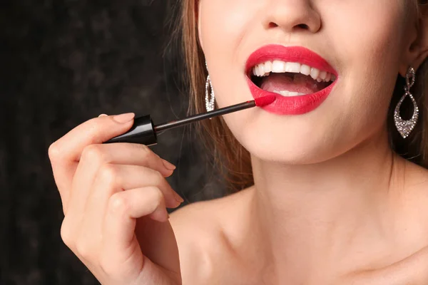 Beautiful Young Woman Applying Bright Red Lipstick Dark Background Closeup — Stock Photo, Image