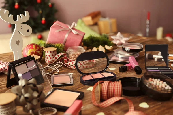 Set of cosmetics with decor for Christmas gifts on wooden table