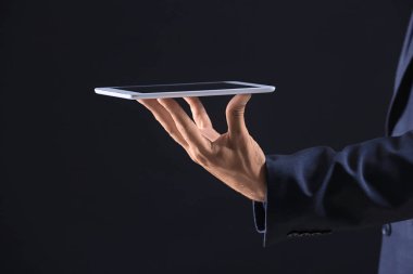 İşadamı ile tablet Pc koyu arka plan üzerinde