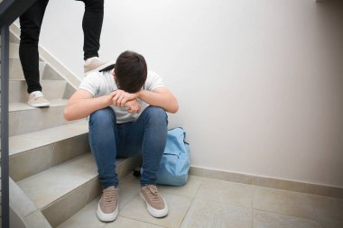 Teenager bullying boy at school clipart